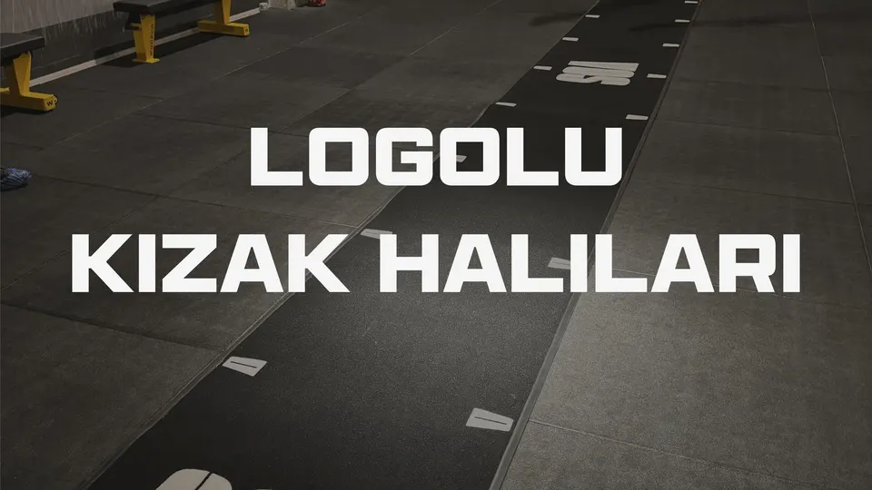 Spor salonunda beyaz logolu siyah kızak halısı